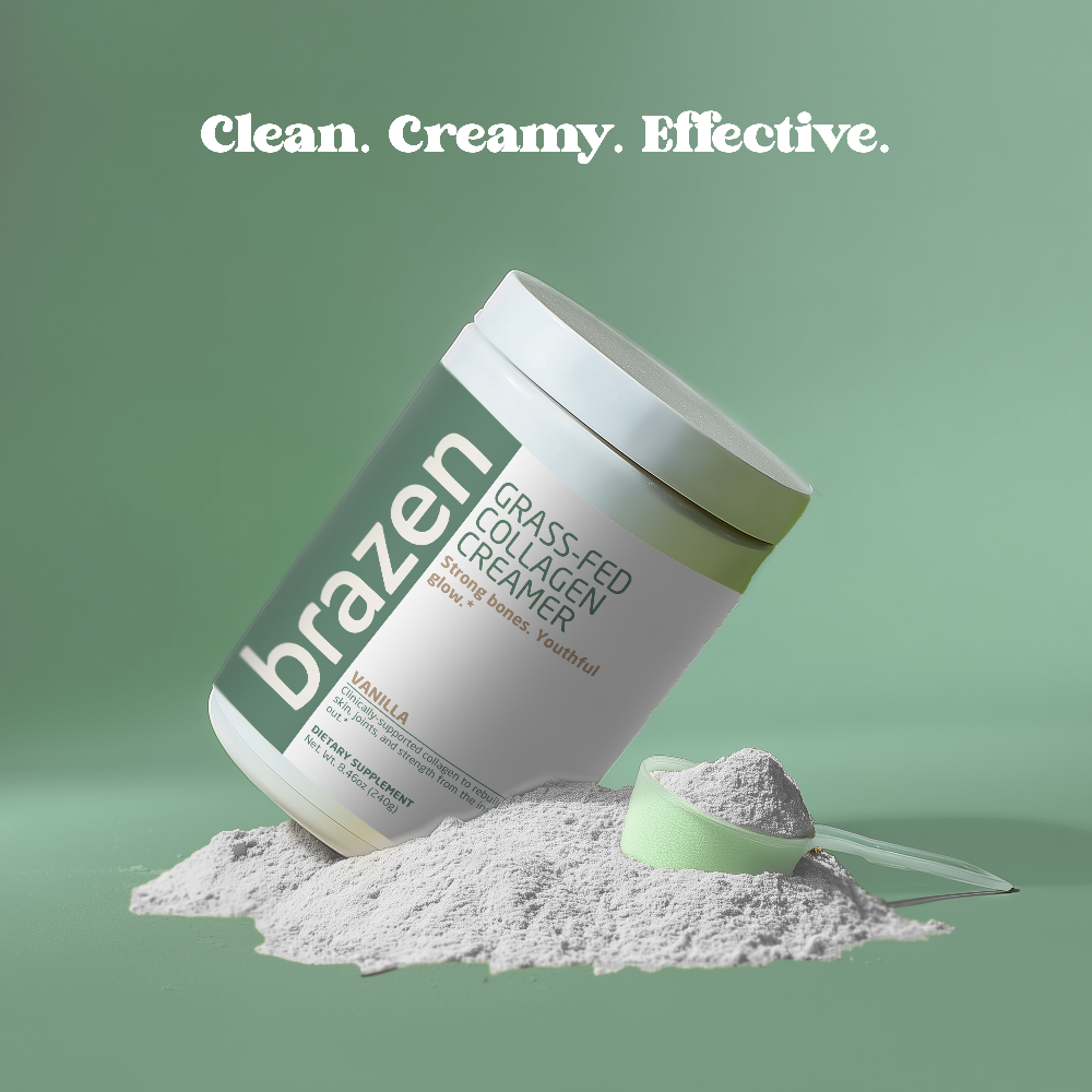 Container of brazen grass fed collagen creamer with powder and scoop on a green background